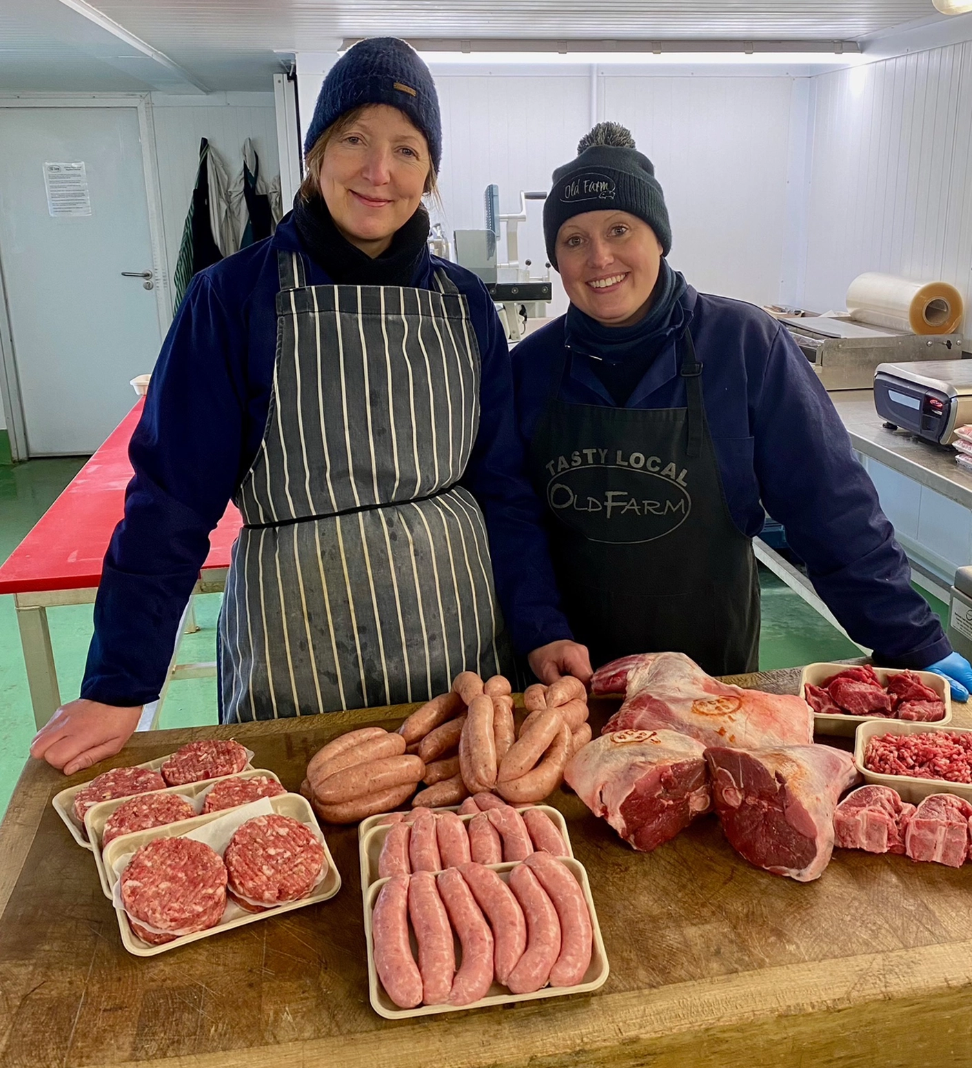 Sarah and Kelly displaying prepared products in the cutting room